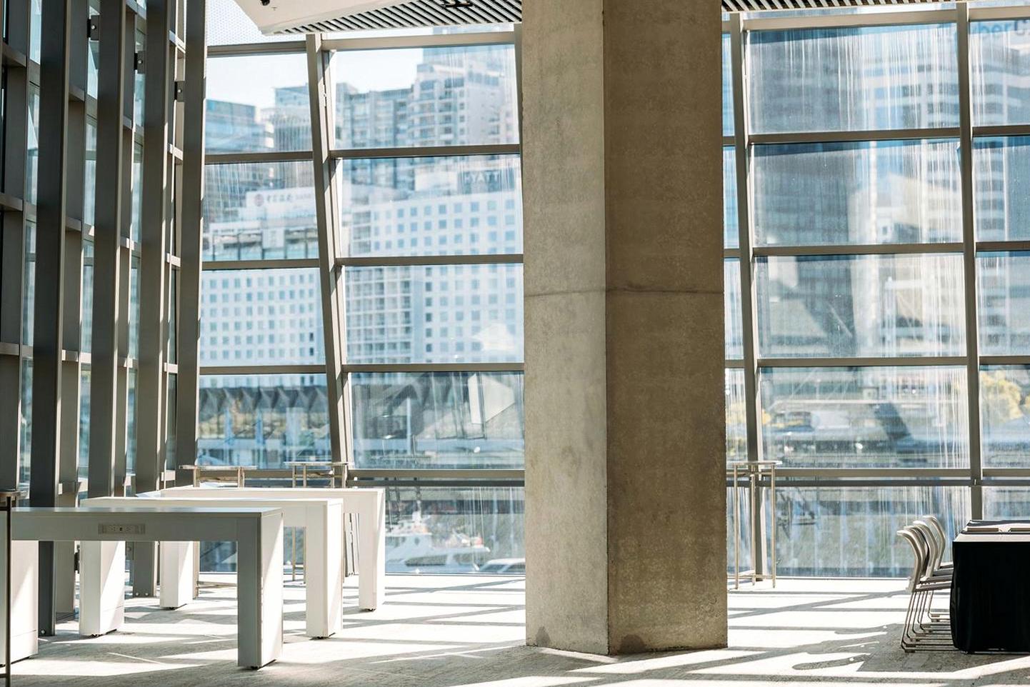 Bright conference area with large windows showcasing Sydney urban landscape